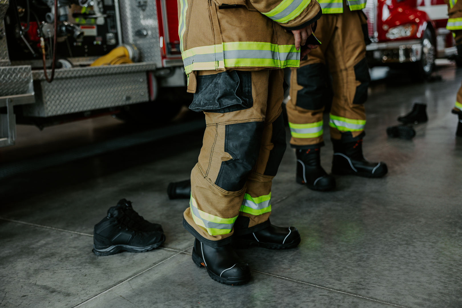firefighters putting on boots in firestation