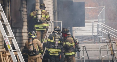 firefighters entering burning building