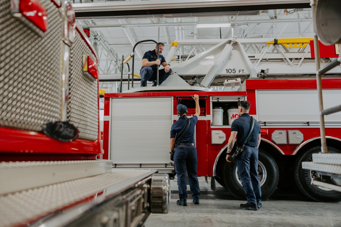 firefighters huddled around firetruck