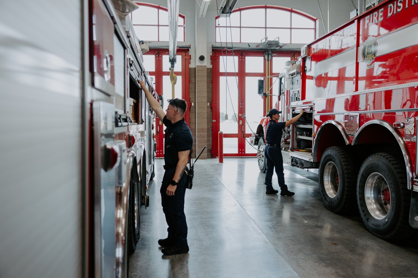 firefighters securing firetruck
