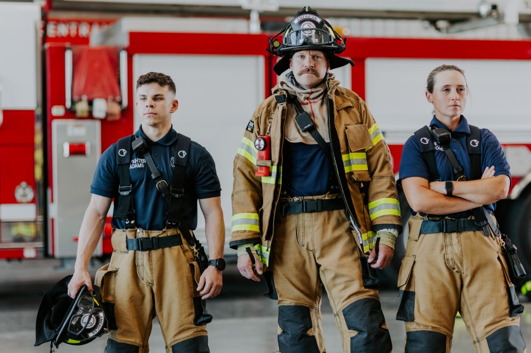firefighters standing in front of fire engine