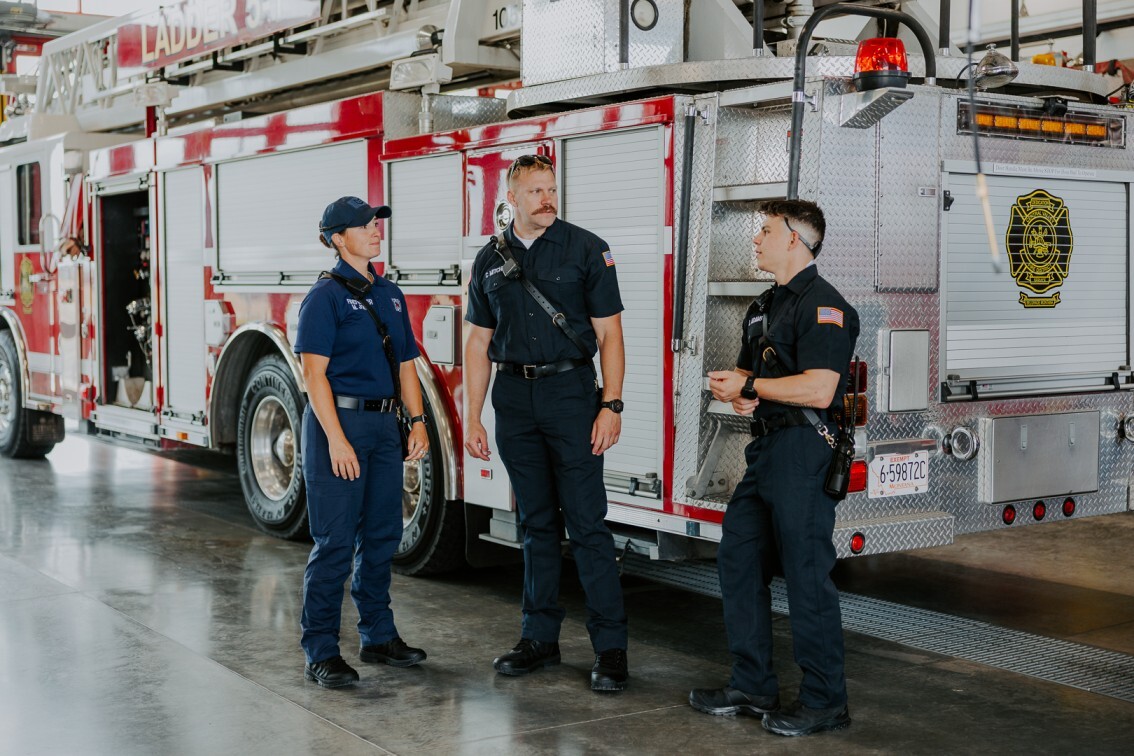 firefighters standing together in fire station